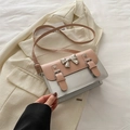 Pink and silver crossbody bag with a metallic bow detail on a cream blazer backdrop - Pink and Silver