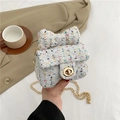 Mini white tweed crossbody bag featuring a decorative bow and gold chain strap - White