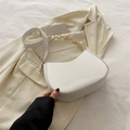 Minimalist white crescent shoulder bag with gold chain strap on beige blazer - White