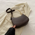Deep brown half-moon underarm bag with golden chain detail on beige blazer - Brown