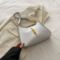 Chic silver underarm bag with gold metal buckle and chain strap on a white blazer - Silver