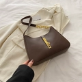 Brown curved underarm bag with gold metal buckle and chunky chain strap detail - Brown