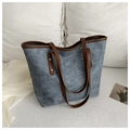 Detalle del bolso tote azul con asas de cuero sintético marrón y remaches dorados - Azul