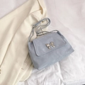 Chic light blue shoulder bag with golden metal bow buckle and elegant chain strap - Blue
