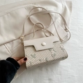 Creamy beige crossbody bag with floral embroidery and textured hollow woven detail - White