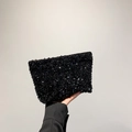 Sparkling black sequin clutch bag for women featuring a shiny finish and zipper closure - Black