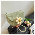 Detail of hand-woven light green saddle bag featuring a 3D white daisy and woven strap - Green