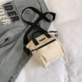 Beige canvas bucket bag with black handles and sport logo strap on denim jacket - Off White