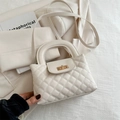 Elegant beige quilted crossbody bag with gold rotating lock and top handle - White