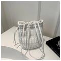 Macro shot of vertical quilted stitching and drawstring detail on white bucket bag - White