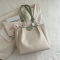 Off-white leather tote bag with pleated design and green shoulder strap details - With Pink Plush Pendant / Green