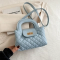 Quilted light blue crossbody handbag with gold twist lock and elegant top handle - Blue