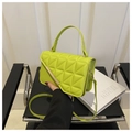 Detail of neon green quilted handbag with geometric pattern and gold metal buckle - Green