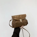 Brown leather crossbody bag with rounded design and golden metal lock closure - Brown