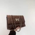 Brown quilted shoulder bag with silver bow clasp and chain strap for women - Brown