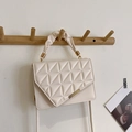Chic quilted cream shoulder bag with geometric stitching and trendy cloud handle - White