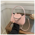 Detail of pink shoulder bag with heart-shaped flap and decorative silver beads - Pink