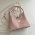 Pink hobo bag with matte fabric finish and integrated shoulder strap in a stylish scene - Pink