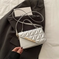 Sleek silver quilted crossbody bag with golden metal trim and sleek shoulder strap - Silver