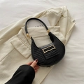 Chic black crocodile embossed hobo bag with gold buckle on white blazer background - Black