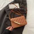 Brown quilted crossbody bag with golden metal trim and a stylish diagonal flap design - Brown