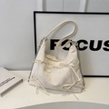 Detail view of the white textured bow tote bag with soft fabric folds and metal chains - Off White