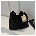 Detail of black nylon bucket bag featuring a side pocket and a cute plush coffee cup charm - Black With Pendant