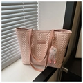 Close-up of pink quilted tote bag with V-shaped stitching and cute fur ball charm - Pink (With Pendant)