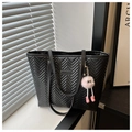Close-up of black chevron quilted tote bag with a cute pink monster plush keychain - Black With Rabbit Pendant