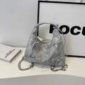 Detail of silver metallic tote bag with decorative bows and sleek chain strap - Silver