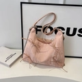 Close-up of pink bow shoulder bag with marble texture and silver chain strap - Pink