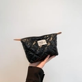 Quilted black puffer pouch with fashion label and zipper closure for daily use - Black