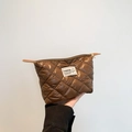 Brown quilted nylon pouch bag featuring a diamond pattern and secure zip closure - Brown