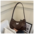 Detail of a brown shoulder bag with a silver butterfly ornament and pleated base - Brown