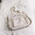 Creamy white large capacity canvas tote bag with multi-pocket utility design and straps - White