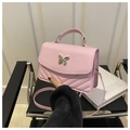 Detailed view of pink quilted crossbody bag with silver butterfly metal clasp buckle - Pink