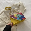 Fashionable bright yellow crossbody bag with colorful geometric patterns and gold chain strap - Yellow