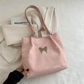 Pink glossy tote bag with metallic butterfly detail and crinkled texture aesthetic - Pink