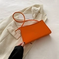 Minimalist bright orange leather shoulder bag with FASHION gold lettering detail - Orange