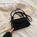 Elegant black marble textured crossbody bag with knotted handle and gold hardware detail - Black