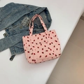 Pink corduroy tote bag with red strawberry print and front pocket on white background - Pink