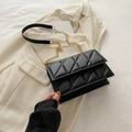 Black quilted crossbody bag with gold chain strap and luxury leather texture - Black