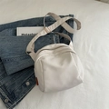 Creamy white nylon shell crossbody bag with adjustable strap and orange side label - White