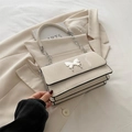 Cream chain crossbody bag with silver butterfly clasp and triple layered design - White