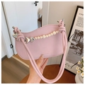 Detailed shot of pink moon bag featuring pearl heart chain and knotted handle - Pink