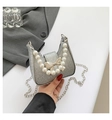 Detail of silver sequin bag with pearl handle, bow ornament, and metal chain - Silver