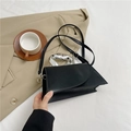 Chic black crossbody bag with a unique silver metal ring handle and adjustable strap - Black