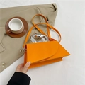 Vibrant orange geometric crossbody handbag with a unique silver metallic handle - Orange
