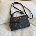 Glossy black glitter handbag with golden star sequins and decorative top handle - Black