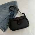 Minimalist black nylon shoulder bag with woven zipper pullers and adjustable strap - Black